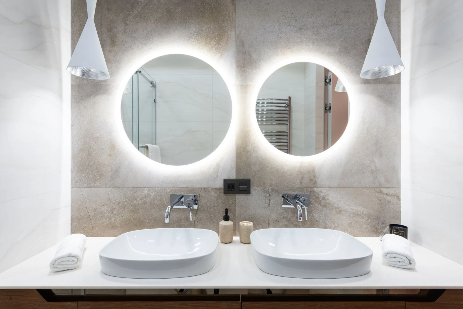 Baño con doble lavamanos y espejos redondos